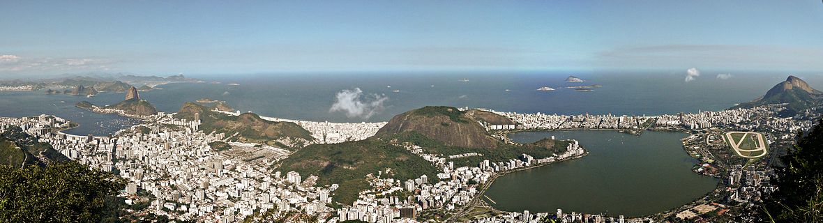 daytime skyline of a city, with a large body of water in front