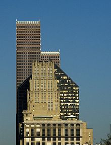 Three skyscrapers visually overlap each other. The simple, rectangular tiers of JPMorgan Chase Building contrast with the five-sided tower of the Pennzoil building and the stepped  rows of spires of the Bank of America building.