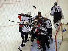 Photo d'arbitres s'interposant entre plusieurs joueurs.