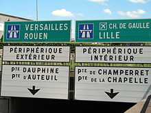 photo de panneaux de signalisation : Lille et périph intérieur à droite, Rouen et périph extérieur à gauche