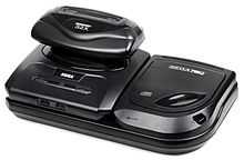 Photo d'une Mega Drive imbriquée dans l'extension Mega-CD, avec le périphérique 32X emboité dans la fente à cartouche de la Mega Drive