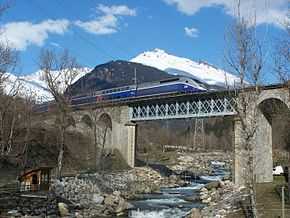 TGV Duplex traversant l'Isère à la sortie de la gare de Bourg-Saint-Maurice