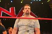 Tommy Dreamer sur un ring portant un T-shirt blanc.