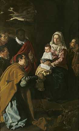 Marie et l'Enfant éclairés dans un puissant clair-obscur, devant eux un roi mage agenouillé au premier plan. D'autres personnages sont dans la pénombre
